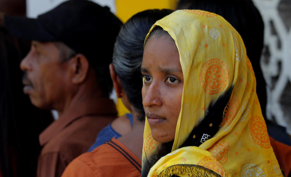 FILE- In this Nov. 16, 2019 file photo, a Sri Lankan Muslim woman waits in a queue to cast her vote at a polling station during the presidential election in Colombo, Sri Lanka.A proposed amendment to Sri Lanka’s constitution that will consolidate powers in the President’s hands has raised concerns about the independence of the country’s institutions and the impact on its ethnic minorities who fear their rights could be undermined by the majoritarian will. (AP Photo/Eranga Jayawardena)