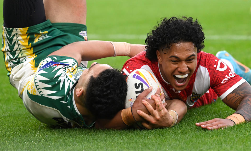 Tesi Niu, pictured here diving over for a try in Tonga's thrashing of Cook Islands at the Rugby League World Cup.