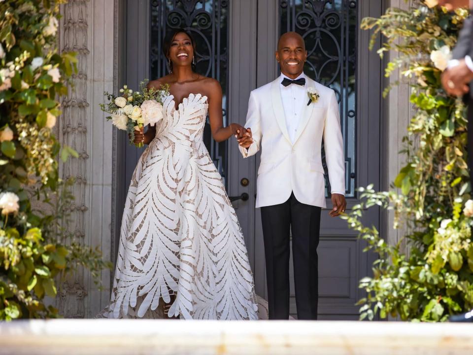 Molly and Taurean smile as they walk into their wedding ceremony.