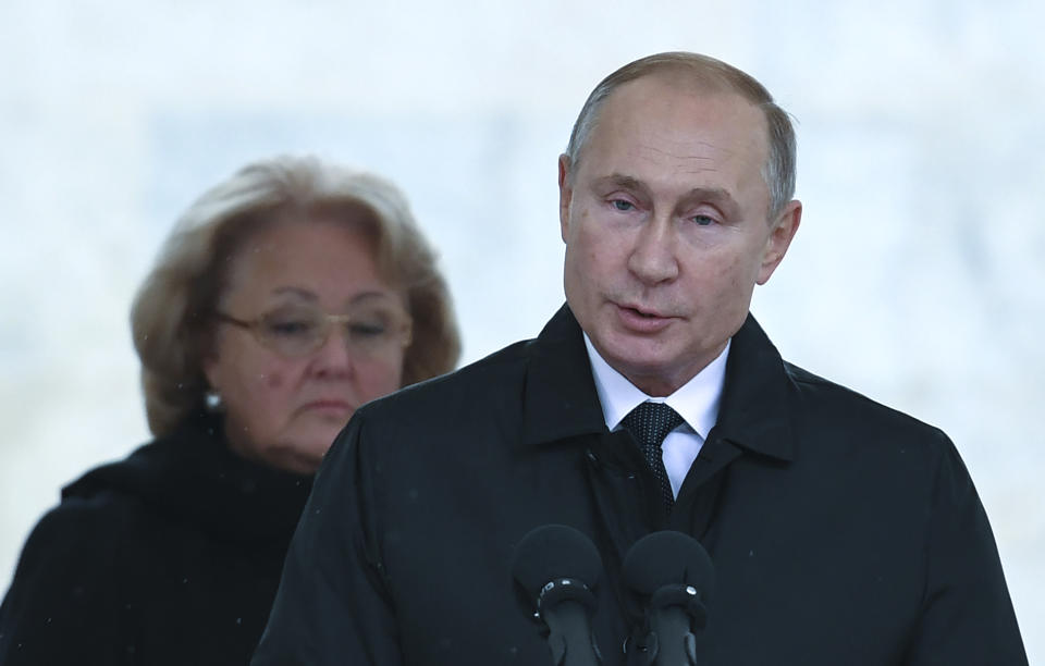 Russian President Vladimir Putin, right, and Yevgeny Primakov's widow Irina attend the unveiling ceremony of a monument to former prime minister Yevgeny Primakov in downtown Moscow, Russia, Tuesday, Oct. 29, 2019. (Yuri Kadobnov/Pool Photo via AP)