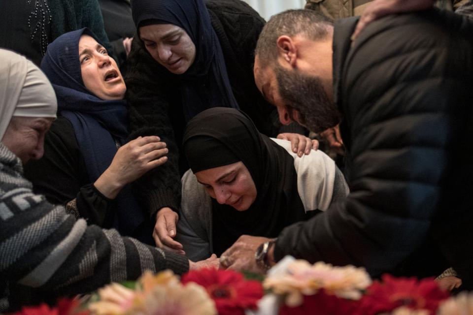 The mother of 17-year-old Palestinian Tawfic Abdel Jabbar mourns over his body before a funeral procession in the Israeli-occupied West Bank on 20 January. (AFP via Getty Images)