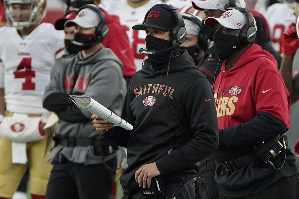 San Francisco 49ers head coach Kyle Shanahan, center, watches from the sideline in the first half of an NFL football game against the New England Patriots, Sunday, Oct. 25, 2020, in Foxborough, Mass. (AP Photo/Steven Senne)