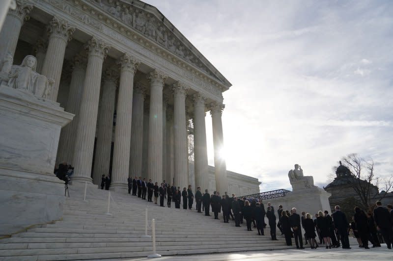 The flag-draped casket of retired Supreme Court Justice Sandra Day O'Connor arrives at the Supreme Court in Washington on Monday as dozens line up to pay their respects. Photo by Bonnie Cash/UPI