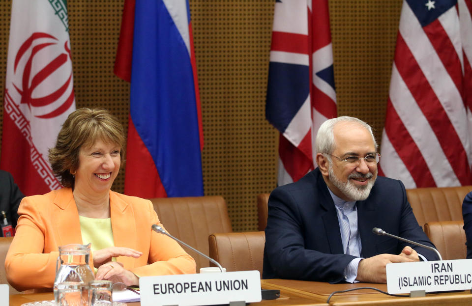 European foreign policy chief Catherine Ashton, left, and Iranian Foreign Minister Mohamad Javad Zarif, right, wait for the start of closed-door nuclear talks in Vienna, Austria, Wednesday, March 19, 2014. Iran and six world powers appear to be tackling less sensitive issues first at nuclear talks meant to curb Tehran's atomic activities in exchange for full sanctions relief. Iran's official IRNA news agency says Wednesday's talks are focusing on a heavy water reactor. The six want the nearly finished reactor shut down, or converted to a type that produces less plutonium, a material that could be used to make nuclear weapons. (AP Photo/Ronald Zak)