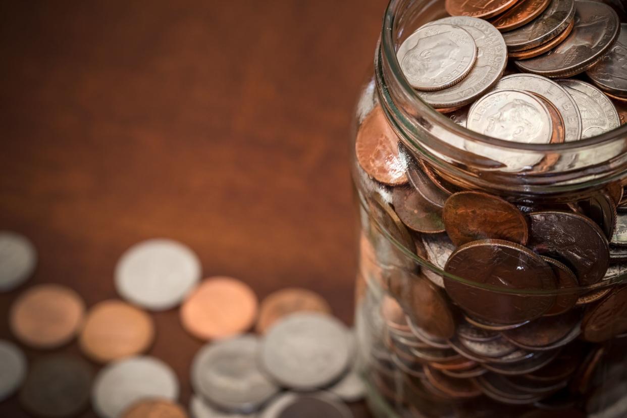 Jar full of american coins photographed from above with copy space.