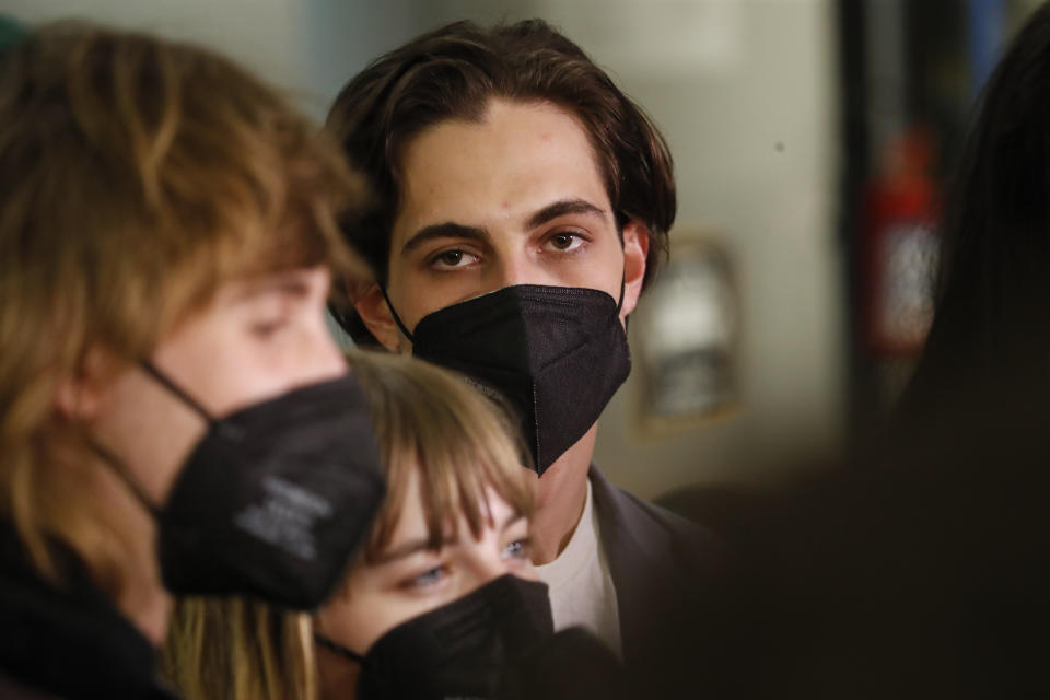 From left Thomas Raggi, Victoria De Angelis, and Damiano David of Italian band Maneskin, listen to reporters' questions upon their arrival at Rome's Fiumicino airport, Sunday, May 23, 2021. The glam rock band who got their start busking on Rome's main shopping drag won the Eurovision Song Contest Saturday and brought next year's competition back to the place where Europe's song contests began. (AP Photo/Alessandra Tarantino)