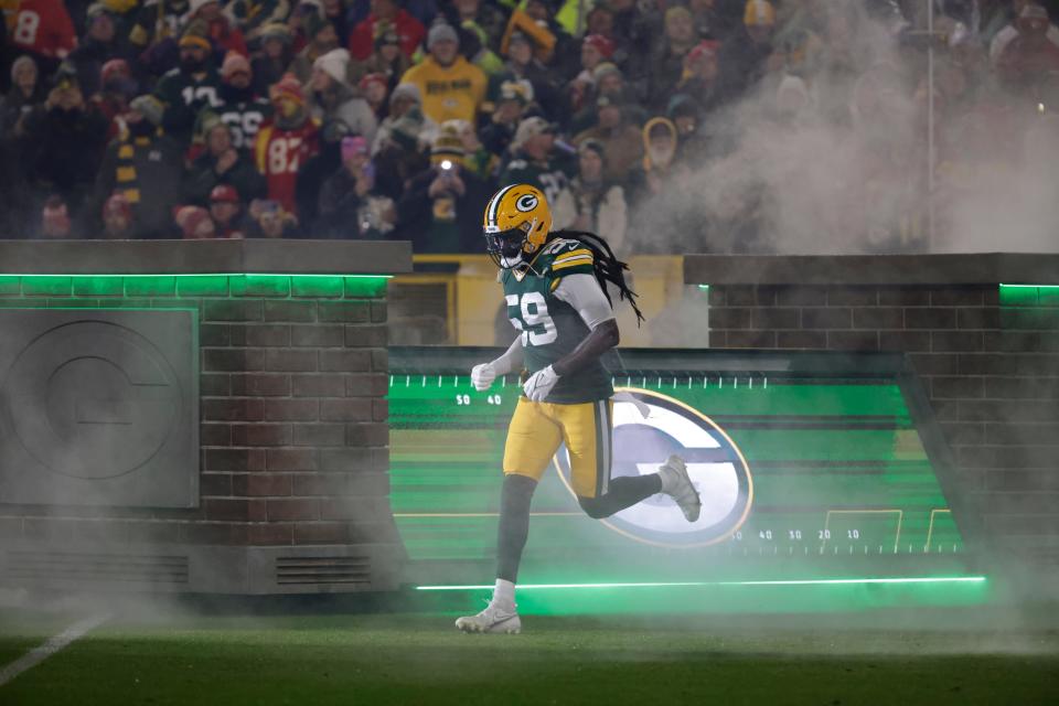 Green Bay Packers linebacker De'Vondre Campbell (59) runs onto the field before the team's game against the Kansas City Chiefs on Sunday, Dec. 3, 2023, at Lambeau Field.