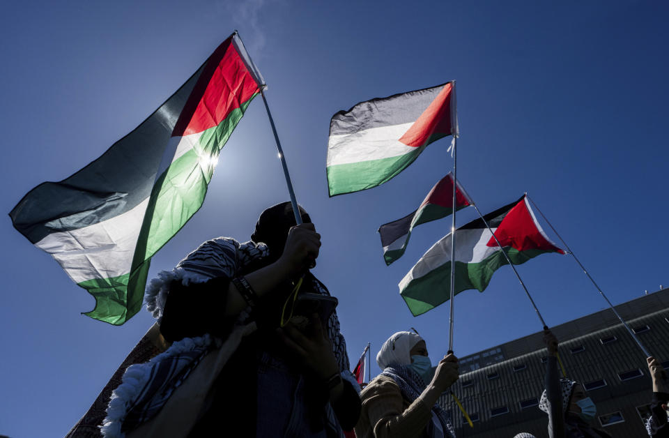 Pro-Palestinian supporters wave flags during a student encampment at the University of British Columbia campus in Vancouver, British Columbia, Canada, on Monday, April. 29, 2024. (Ethan Cairns/The Canadian Press via AP)