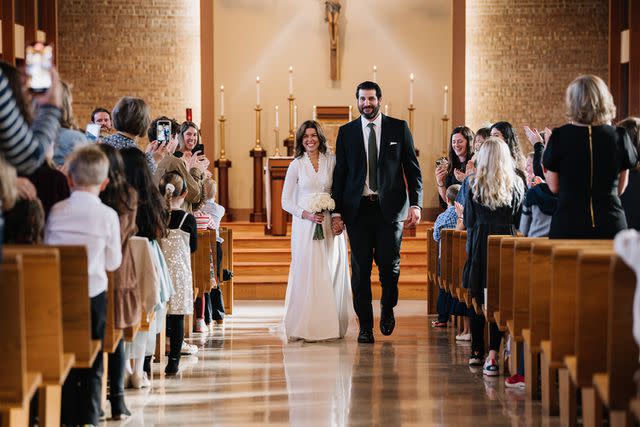 <p>Adam Kennedy Photography</p> Catie and Kevin Zwier walking down the aisle