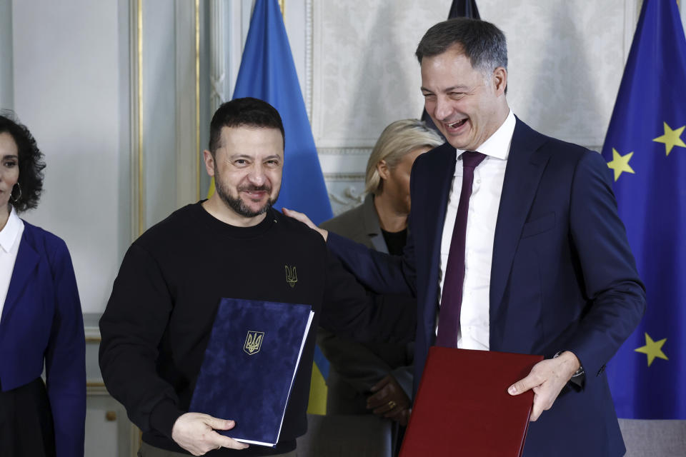 Ukraine's President Volodymyr Zelenskyy, left, and Belgium's Prime Minister Alexander De Croo pose after signing a bilateral security agreement during their meeting at the prime ministers' office in Brussels, Tuesday, May 28, 2024. (Kenzo Tribouillard/Pool Photo via AP)