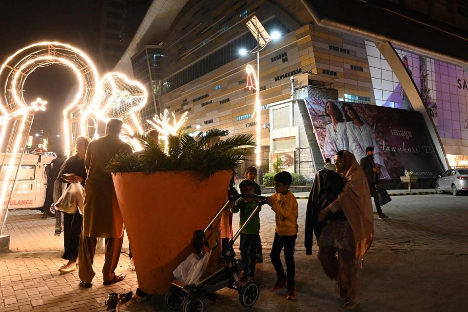 People gather outside a mall following an earthquake in Islamabad, Pakistan (AFP via Getty Images)