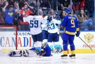 Sep 25, 2016; Toronto, Ontario, Canada; Team Europe forward Tomas Tatar (21) is mobbed by teammates after scoring the winning goal in overtime past Team Sweden goalie Henrik Lundqvist (30) in a semifinal game in the 2016 World Cup of Hockey at Air Canada Centre. Mandatory Credit: Dan Hamilton-USA TODAY Sports