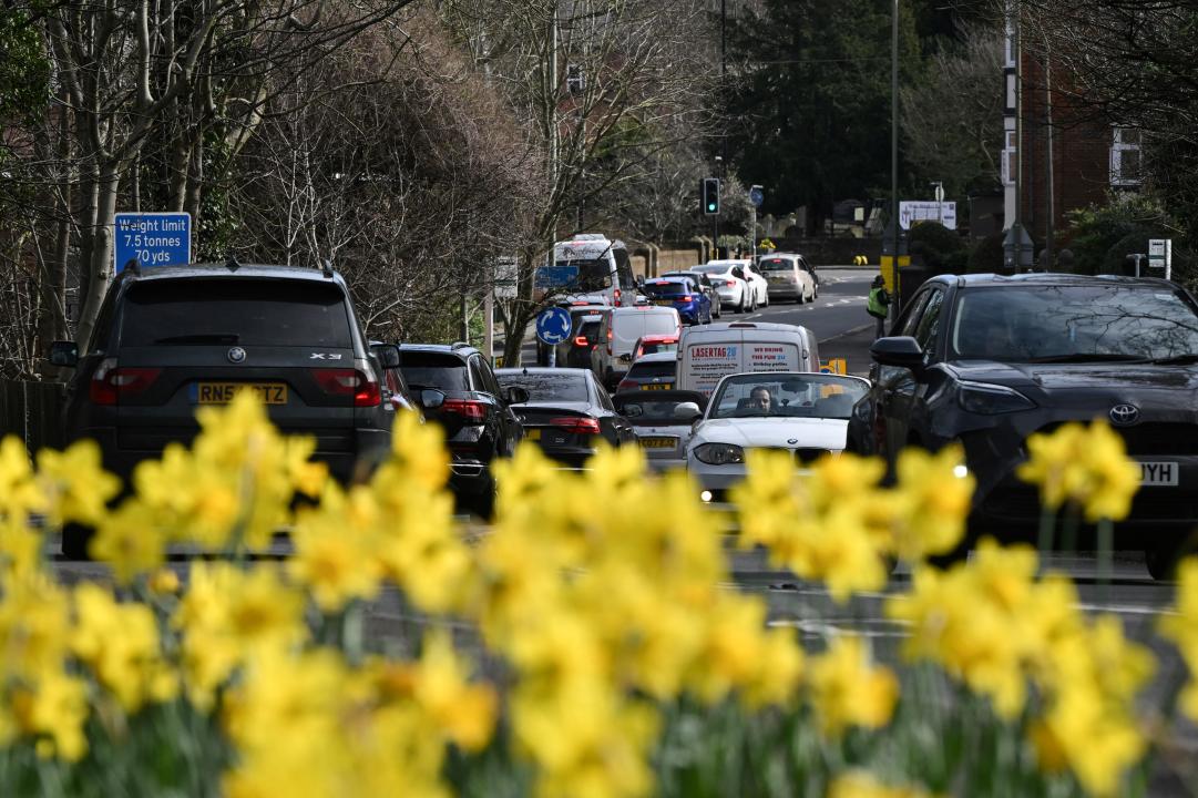Vehicles queue along the street going into Weybridge south-west of London on March 16, 2024, as the London orbital motorway M25 sees it's first total closure over a weekend since it's opening in 1986. The M25 will be closed between junctions 10 and 11 from Friday 15 March 2024 evening until Monday 18 March 2024 morning to demolish the Clearmount bridleway bridge and install a very large gantry. (Photo by JUSTIN TALLIS / AFP) (Photo by JUSTIN TALLIS/AFP via Getty Images)