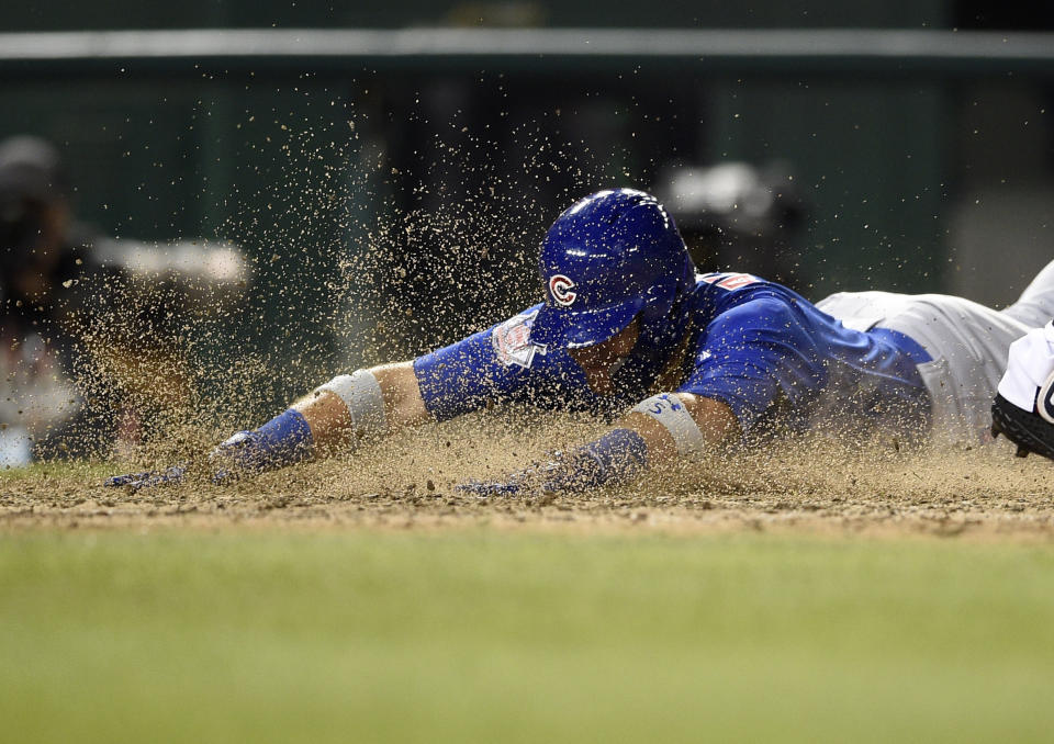 Chicago Cubs' Albert Almora Jr. slides home to score on a double by David Bote during the 10th inning of a baseball game against the Washington Nationals, Thursday, Sept. 6, 2018, in Washington. The Cubs won 6-4. (AP Photo/Nick Wass)