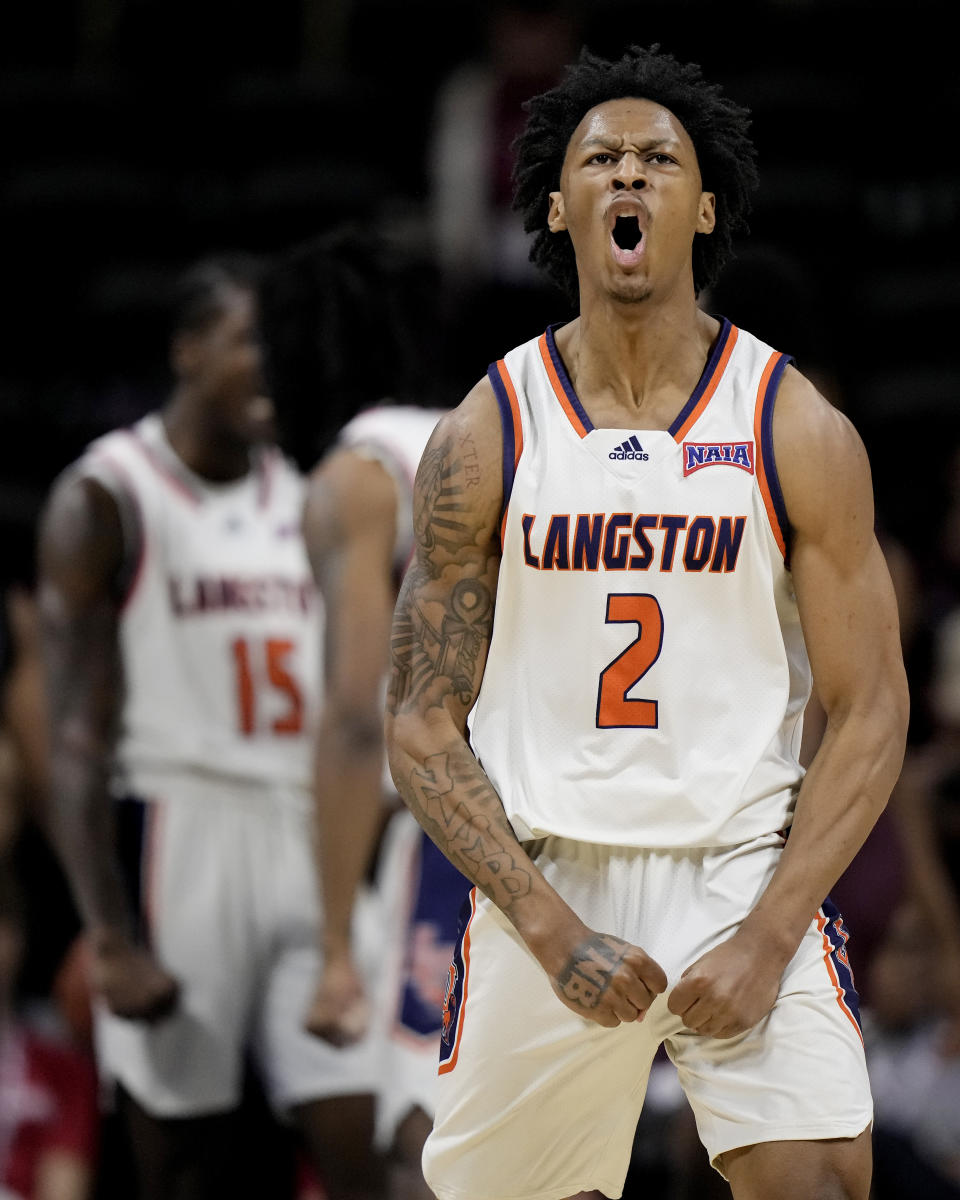 Langston guard Anthony Roy celebrates a teammate's basket during the first half of the NAIA men's national championship college basketball game against Freed-Hardeman, Tuesday, March 26, 2024, in Kansas City, Mo. (AP Photo/Charlie Riedel)