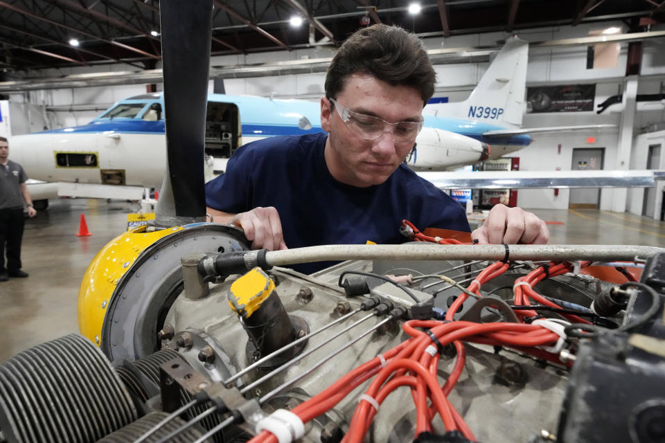 Student William Onderdork studies an engine on a Cessna 310 aircraft at Pittsburgh Institute of Aeronautics in West Mifflin, Pa., Tuesday, May 2, 2023. Students graduating from PIA have been awed by how much they're in demand. Recruiters are desperately seeking more aircraft mechanics for the airlines, airplane manufacturers, and repair shops that need them. (AP Photo/Gene J. Puskar)