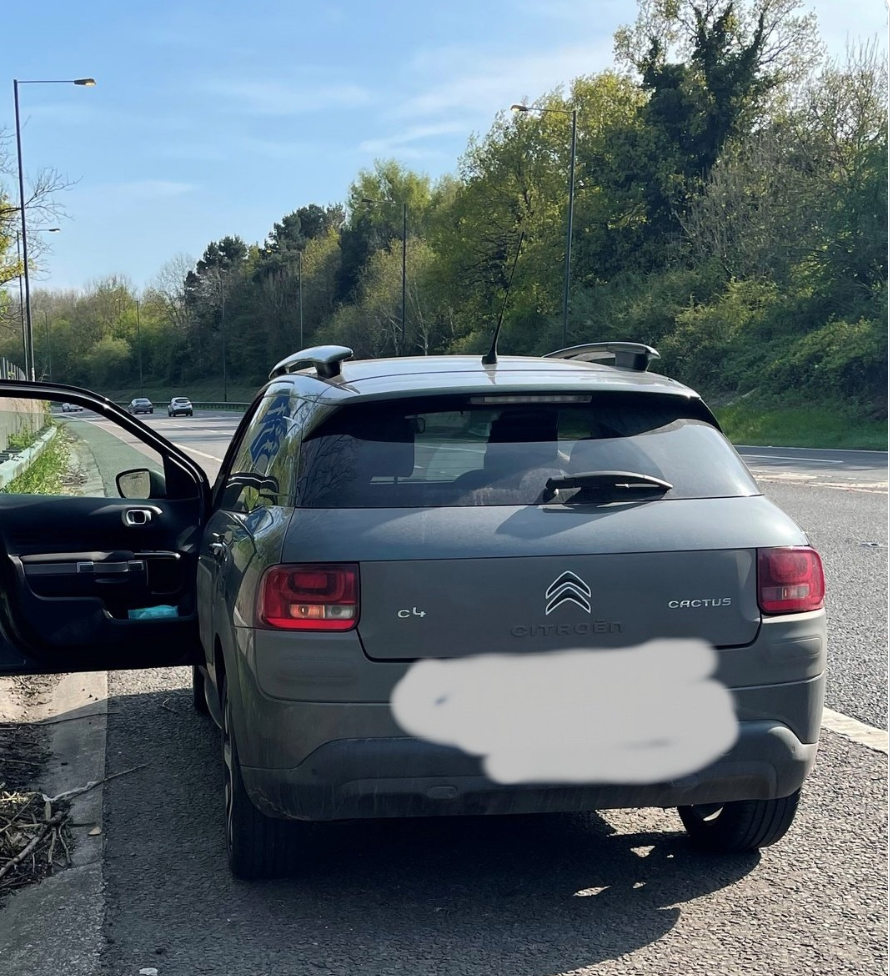 North West Motorway Police shared an image of a car pulled over on the hard shoulder of a motorway while waiting to collect passengers from Manchester Airport. (Twitter/North West Motorway Police)