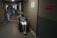 An elderly homeless man uses a wheelchair at the hospital for the homeless in Budapest, Hungary, Wednesday, April 14, 2021. A bitter conflict has emerged between Hungary’s right-wing government and the liberal leadership of the country's capital city over a hospital for the homeless that may soon have to close. The Budapest hospital provides medical and social services and shelter to more than 1,000 people annually. But the Hungarian government has ordered it to vacate the state-owned building it occupies. Budapest's mayor says the eviction will risk the lives of the hospital's homeless patients as Hungary struggles with a deadly COVID-19 surge. (AP Photo/Laszlo Balogh)