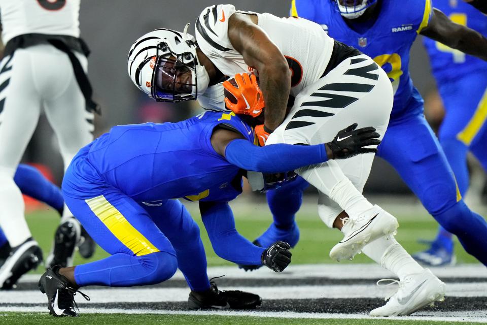 Cincinnati Bengals running back Joe Mixon (28) carries the ball as Los Angeles Rams cornerback Derion Kendrick (1) defends in the first quarter during a Week 3 NFL football game between the Los Angeles Rams and the Cincinnati Bengals, Monday, Sept. 25, 2023, at Paycor Stadium in Cincinnati.