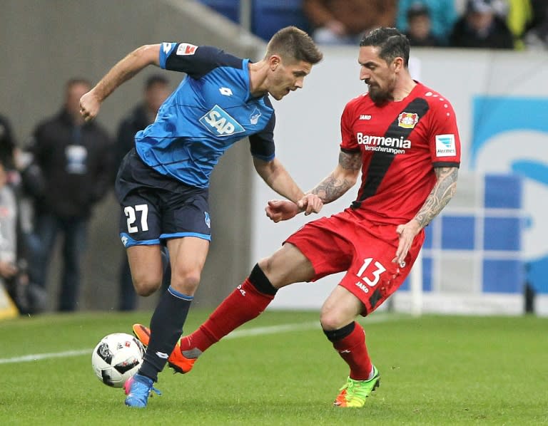 Hoffenheim's forward Andrej Kramaric and Leverkusen's defender Roberto Hilbert vie for the ball during the German first division Bundesliga football match March 18, 2017