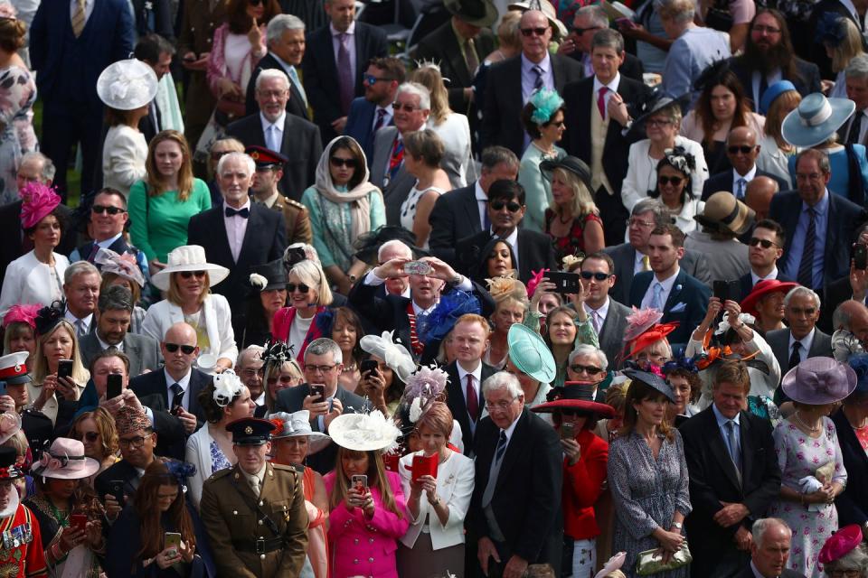 <p>The crowd of guests at today's party at Buckingham Palace. Over the course of multiple garden parties, more than 30,000 guests will be invited to spend time in the gardens of Buckingham Palace and the Palace of Holyroodhouse. </p>