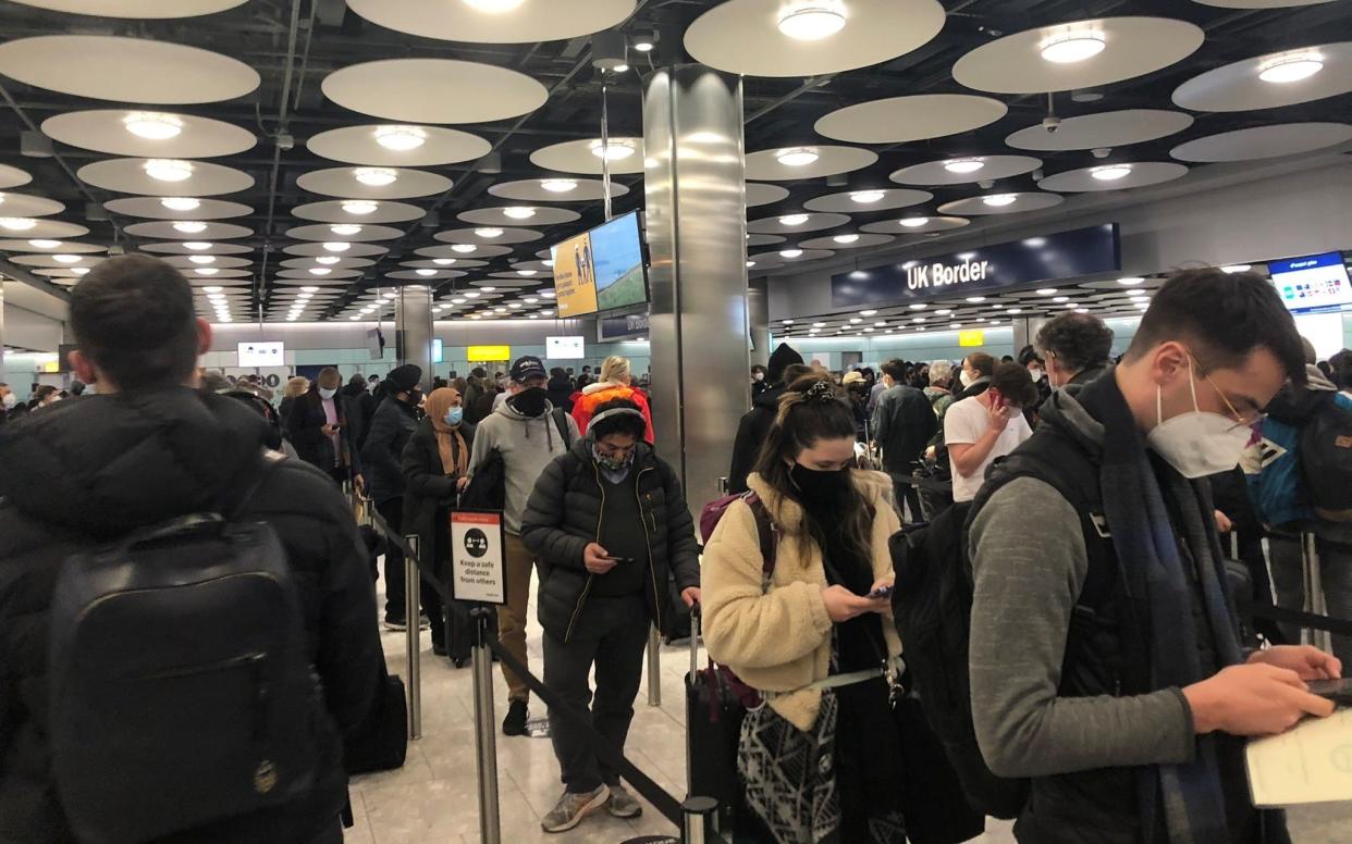 People queue at terminal 5 of Heathrow Airport on January 22 as the spread of the coronavirus disease continues - PIA JOSEPHSON via REUTERS