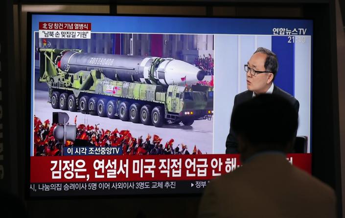 A man watches a TV screen showing a North Korean ICBM at a train station in Seoul, South Korea.