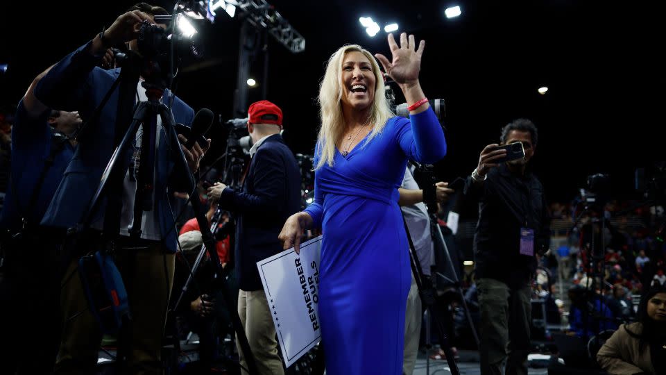 US Rep. Marjorie Taylor Greene waves to supporters at the rally in Rome, Georgia, on March 9, 2024, while holding a poster with the image of Laken Riley. - Chip Somodevilla/Getty Images