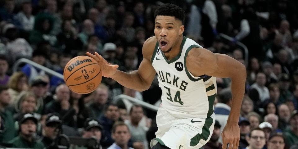 Giannis Antetokounmpo dribbles the ball and drives the lane during a Bucks game.