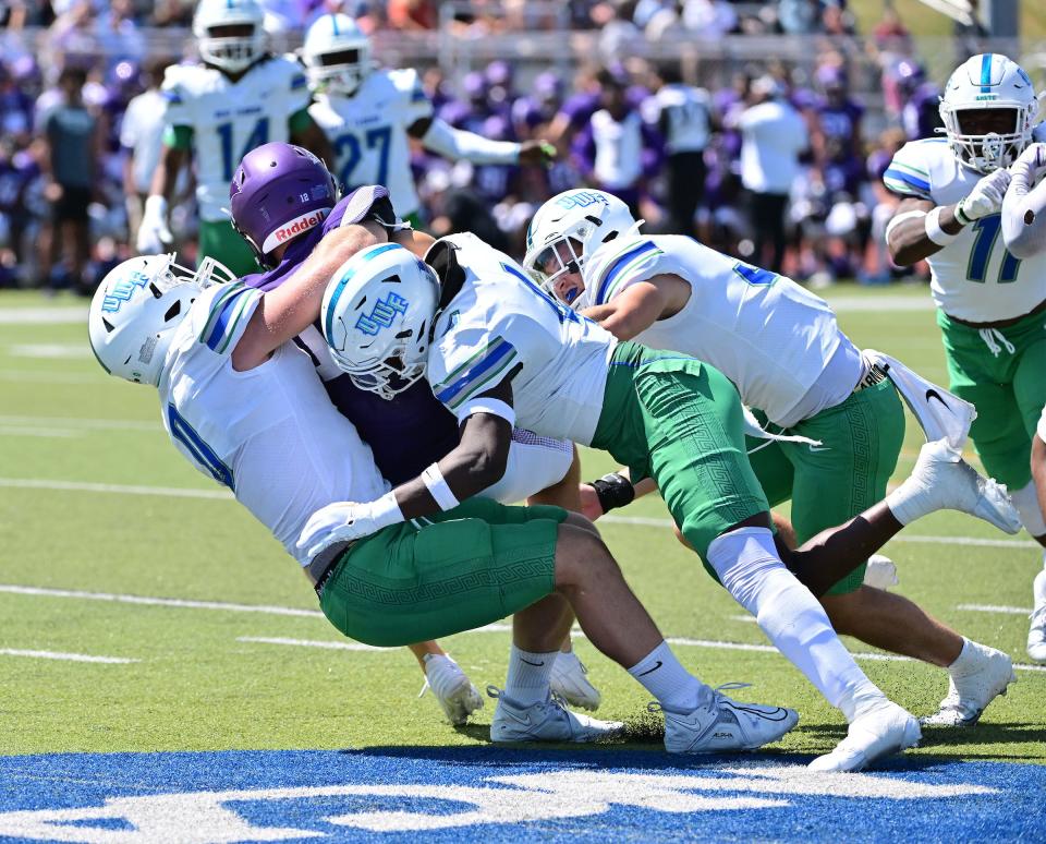 A gang of University of West Florida defenders sack McKendree University quarterback Caleb Fisher during the Argos' 35-3 win over the Bearcats on Saturday, Sept. 9, 2023, at Leemon Field in Lebanon, Illinois.