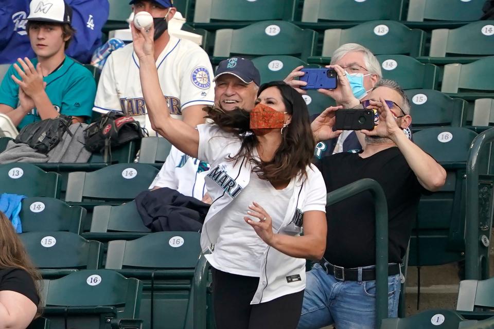 Jessica Mendoza, an Olympic medal-winning softball player and current ESPN broadcaster, throws out the ceremonial first pitch of a baseball game between the Seattle Mariners and the Los Angeles Dodgers in Seattle, in this Monday, April 19, 2021, file photo.