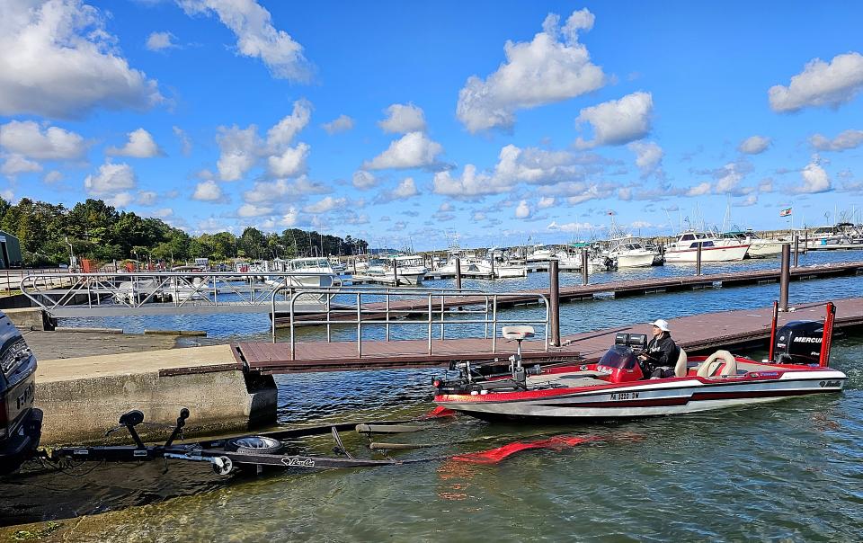 Reuben Bartholomew, 45, of the Poconos, loads his boat onto a trailer at the North East Marina Thursday, Sept. 15, 2023. Bartholomew was visiting Erie for The Bass Federation's national semifinals competition. The marina, which is facing significant changes due to higher maintenance costs, attracts people from several states each year for fishing. Bartholomew said the marina offers a 