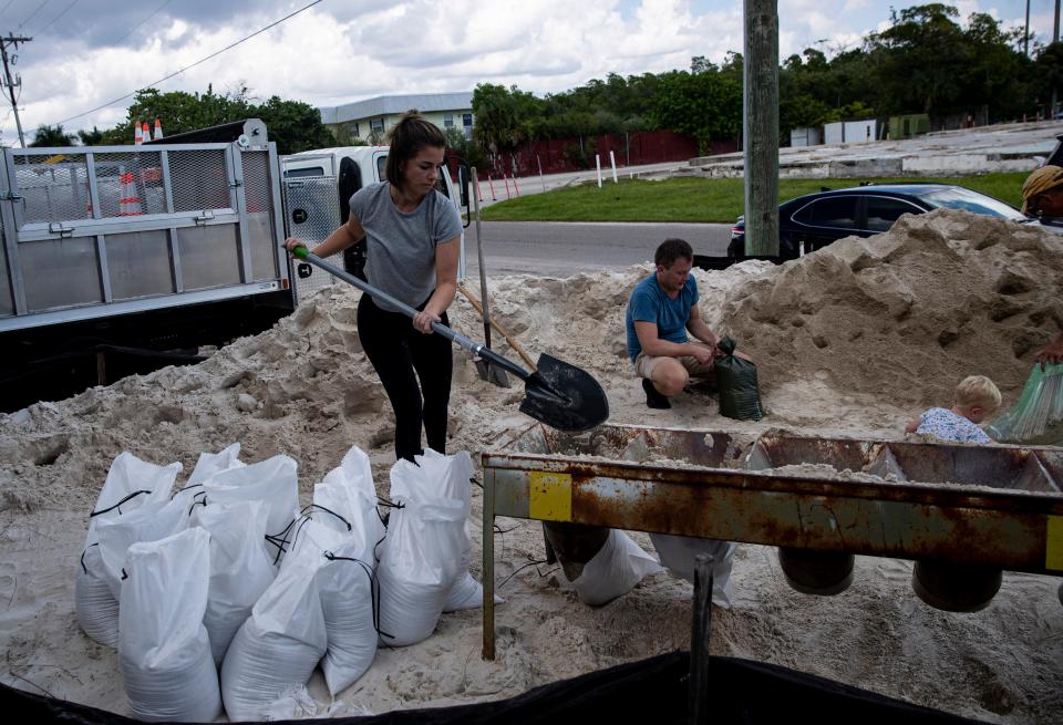 Fort Myers resident, Sarah Peterson fills sand bags at Fort Myers Beach town hall  on Fort Myers Beach in anticipation of Hurricane Ian on Saturday Sept. 24, 2022.