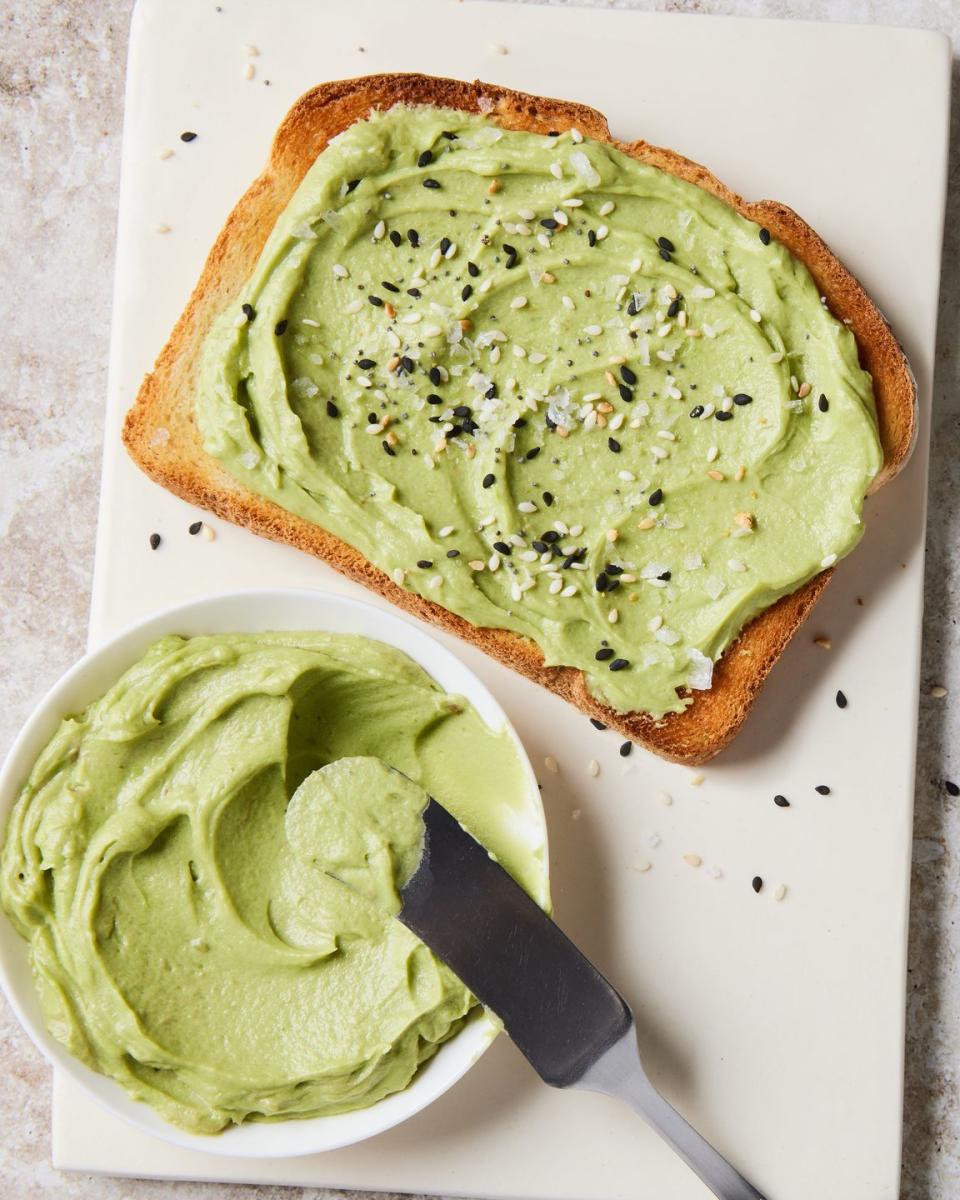 whipped green avocado butter in a yellow ramekin