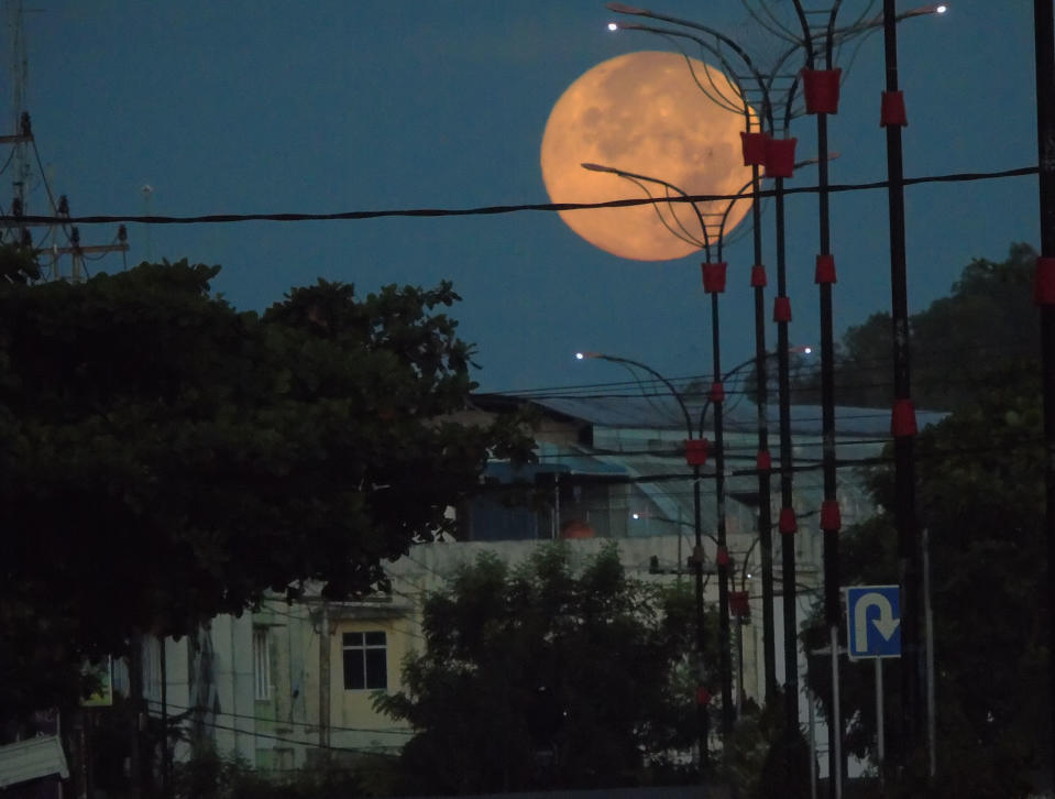 A view of Perigee Supermoon seen in Bintan island, Indonesia on April 8, 2020. The biggest full moon super pink moon perigee can be watched in Indonesian sky. The pink supermoon, sometimes called the Easter full moon, fills the night sky with a bright and radiant spring. (Photo credit Yuli Seperi / Sijori Images/Barcroft Media via Getty Images)