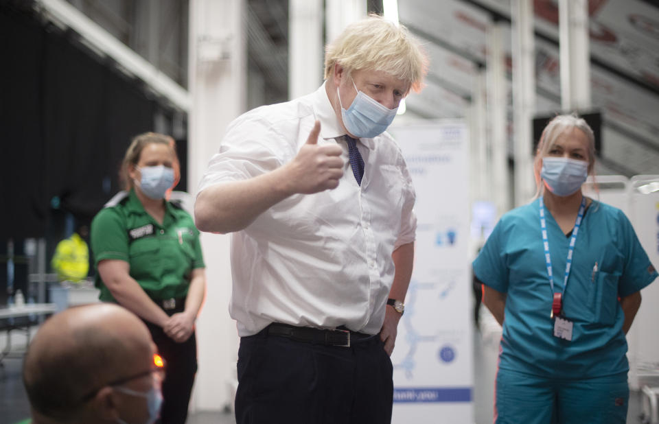 Britain's Prime Minister Boris Johnson speaks to patients and staff at a mass vaccination centre at Ashton Gate stadium in Bristol, southwest England on January 11, 2021. - Seven mass coronavirus vaccination sites opened across England on Monday as the government races to dose millions of people while a new strain of the disease runs rampant across the country. (Photo by Eddie MULHOLLAND / POOL / AFP) (Photo by EDDIE MULHOLLAND/POOL/AFP via Getty Images)