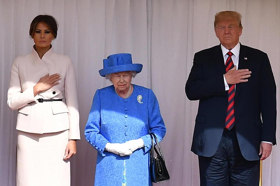 U.S. President Donald Trump and First Lady Melania Trump stand with Britain’s Queen Elizabeth on the dais during the U.S. national anthem in the Quadrangle at Windsor Castle, Windsor