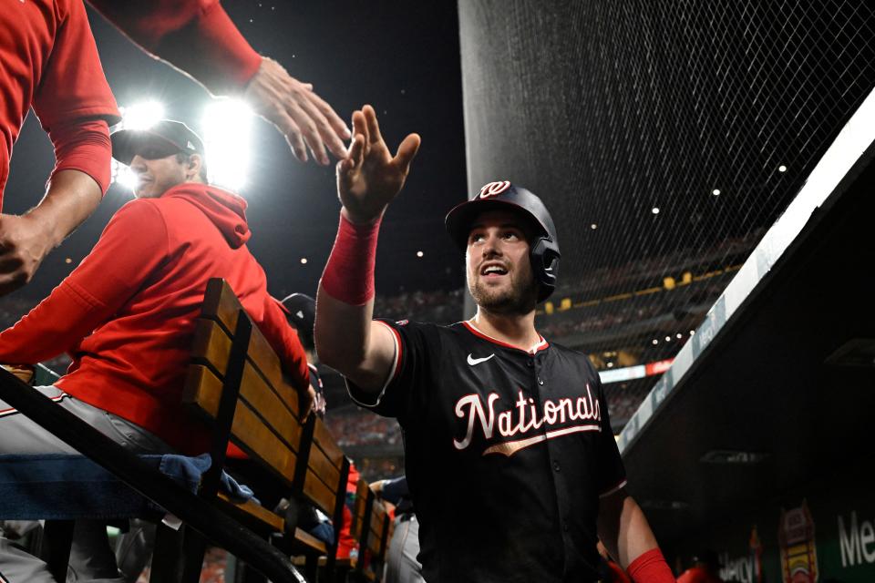 Nationals right fielder Lane Thomas celebrates with teammates after scoring on a Jesse Winker third-inning single against the Cardinals, July 27, 2024, in St. Louis.