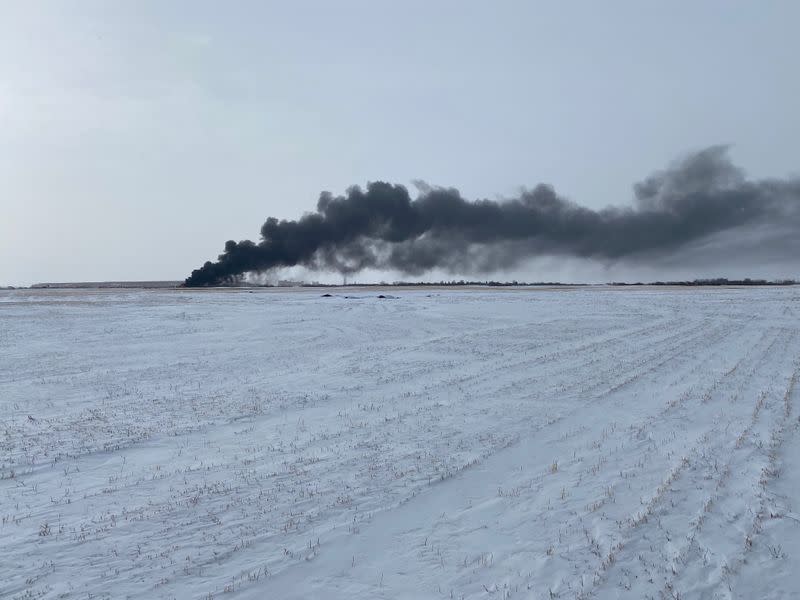 Smoke rises from the site of burning railcars at a CP Rail train derailment near Guernsey