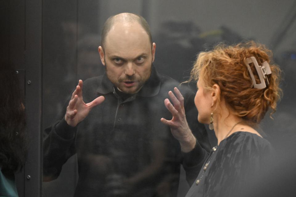 FILE - Russian opposition activist Vladimir Kara-Murza, standing in a defendants’ cage, speaks with his lawyer in a courtroom in Moscow, Russia, on July 31, 2023. Kara-Murza was convicted of treason in 2023 for denouncing the conflict in Ukraine and is serving a 25-year prison term in a Siberian prison colony, the stiffest sentence for a Kremlin critic in modern Russia. (AP Photo/Dmitry Serebryakov, File)