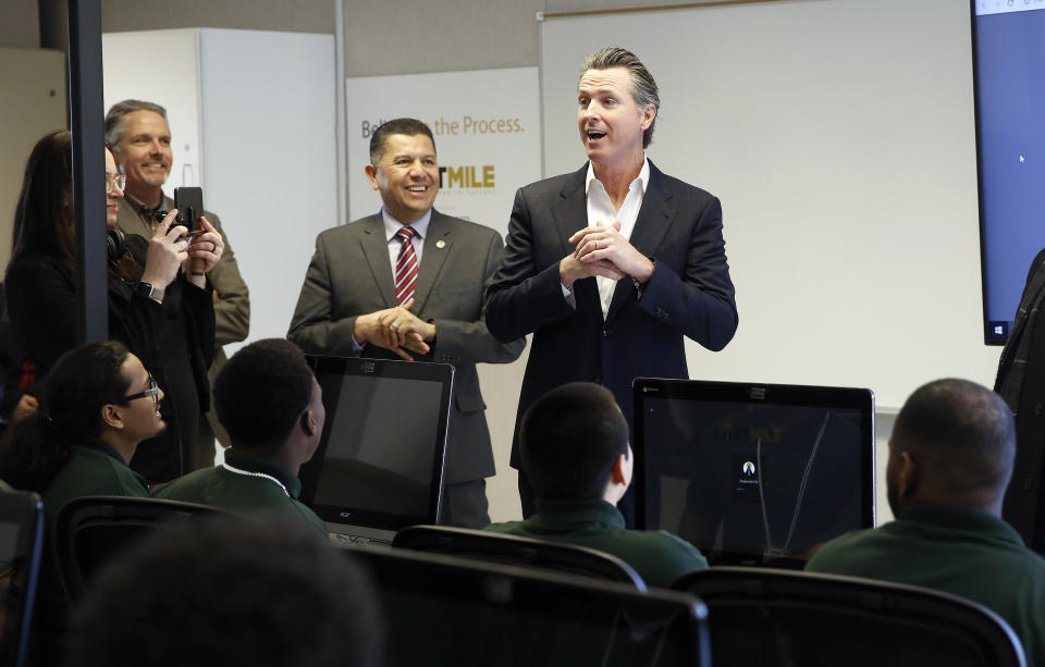 FILE - In this Jan. 22, 2019 file photo, Gov. Gavin Newsom, right, addresses youthful offenders taking a computer coding class at the O.H. Close Youth Correctional Facility in Stockton, Calif. Legionnaires' disease bacteria that killed one inmate and sickened another is more widespread than expected in a California state prison, officials said Wednesday, April 17, 2019, citing new test results. Preliminary results found the bacteria in the water supply at a prison medical facility in Stockton and at two neighboring youth correctional facilities, said Corrections Department spokeswoman Vicky Waters. (AP Photo/Rich Pedroncelli, File)