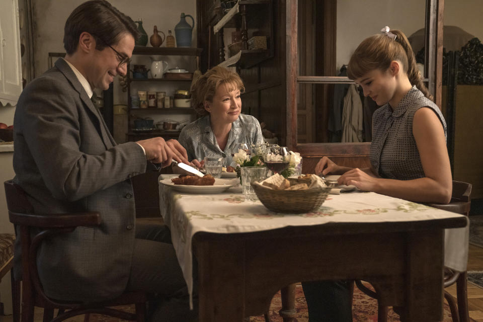 This image released by Focus Features shows Lucas Bravo, from left, Lesley Manville and Alba Baptista in a scene from "Mrs. Harris Goes to Paris." (Liam Daniel/Focus Features via AP)