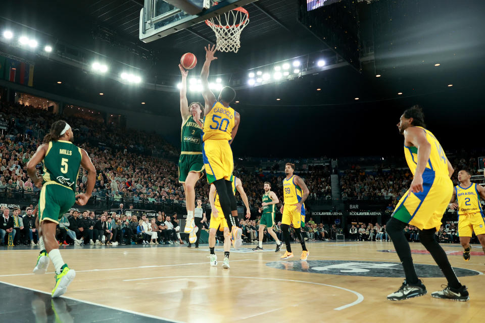 MELBOURNE, AUSTRALIA – AUGUST 16: Josh Giddey of Australia shoots the ball past Bruno Caboclo of Brazil during the match between the Australia Boomers and Brazil at Rod Laver Arena on August 16, 2023 in Melbourne, Australia. (Photo by Kelly Defina/Getty Images)