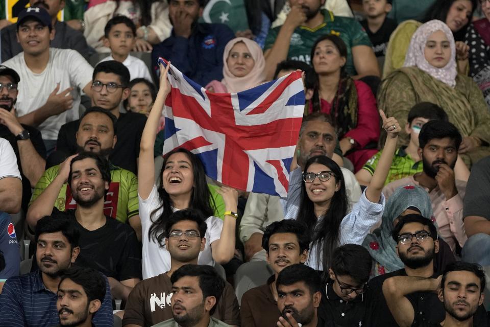 Cricket fans cheers for England team during the sixth twenty20 cricket match between Pakistan and England, in Lahore, Pakistan, Friday, Sept. 30, 2022. (AP Photo/K.M. Chaudary)