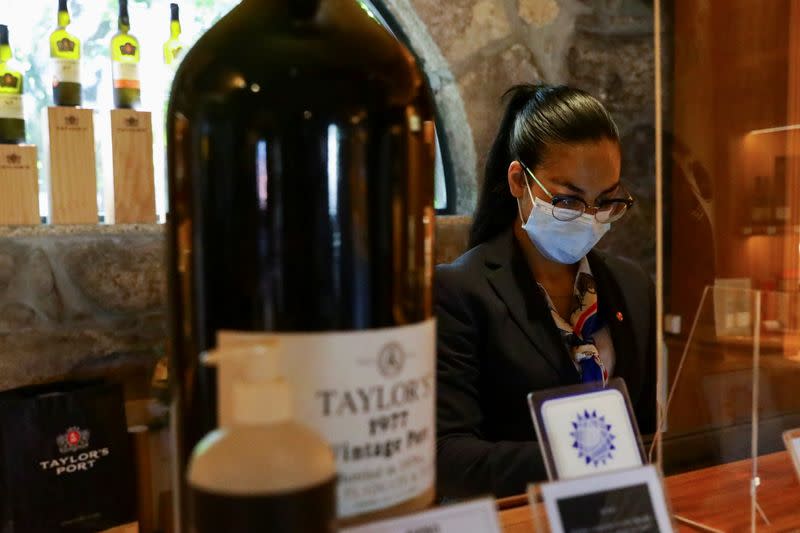 Taylor's Port Wine staff works at the cellars' gift-shop, in Porto