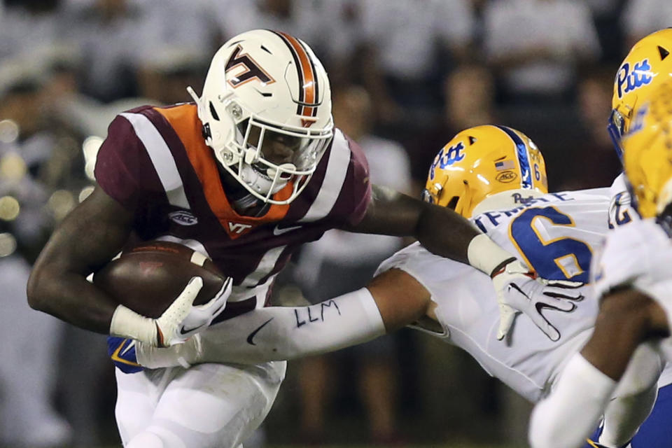 Virginia Tech running back Malachi Thomas (24) is tackled near the line of scrimmage by Pittsburgh defender Nate Temple (6) during the second quarter of an NCAA college football game Saturday, Sept. 30, 2023, in Blacksburg, Va. (Matt Gentry/The Roanoke Times via AP)