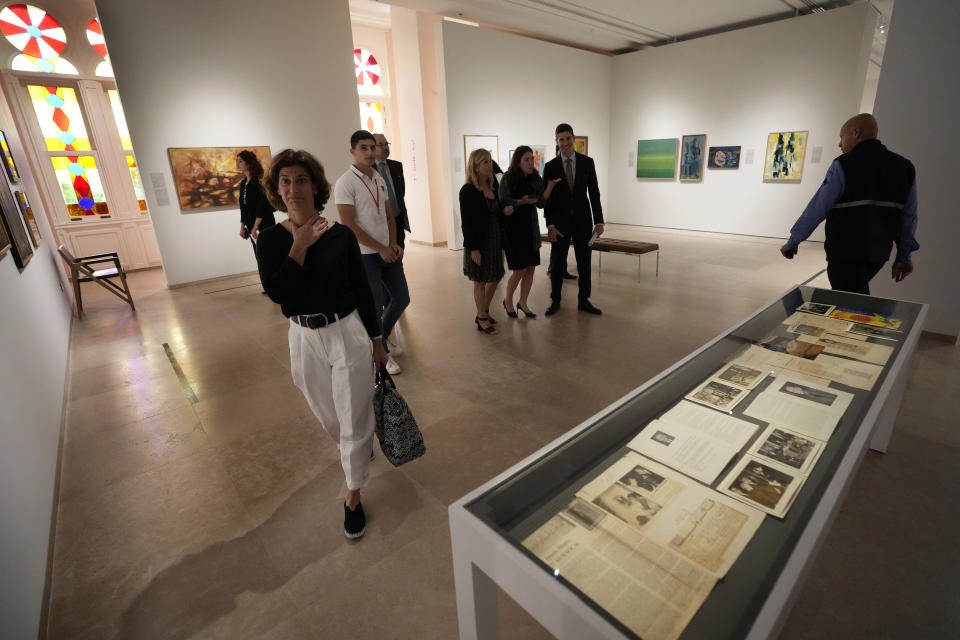 Guests tour the Sursock Museum's exhibitions after relaunching an opening event for the iconic venue in Beirut, Lebanon, Friday, May 26, 2023. The museum has reopened to the public, three years after after a deadly explosion in the nearby Beirut port reduced many of its treasured paintings and collections to ashes. (AP Photo/Hussein Malla)