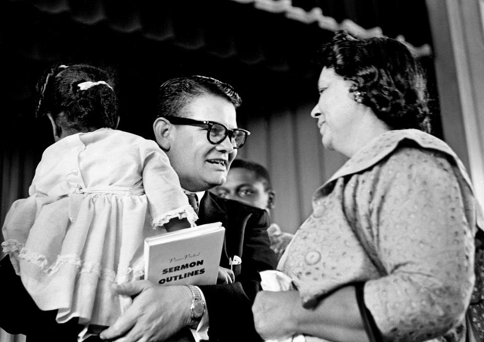 Former Texas financier Billie Sol Estes, church sermon in hand, receives a warm greeting April 17, 1963 from the audience at the Nashville Christian Institute, a private school for black children. Estes, the convicted Texas swindler who vast financial empire collapsed last year into a rubble of worthless mortgages, was hugged, prayed over and offered financial help when he visited the institute.