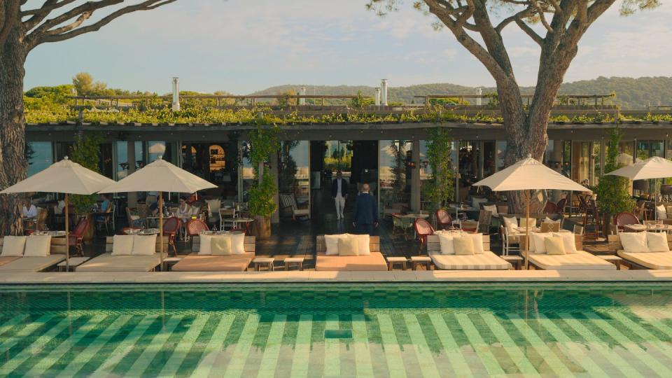 a pool with umbrellas and chairs