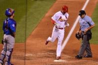 Oct 9, 2015; St. Louis, MO, USA; St. Louis Cardinals left fielder Stephen Piscotty (55) touches home plate after hitting a home run during the eighth inning against the Chicago Cubs in game one of the NLDS at Busch Stadium. Mandatory Credit: Jasen Vinlove-USA TODAY Sports